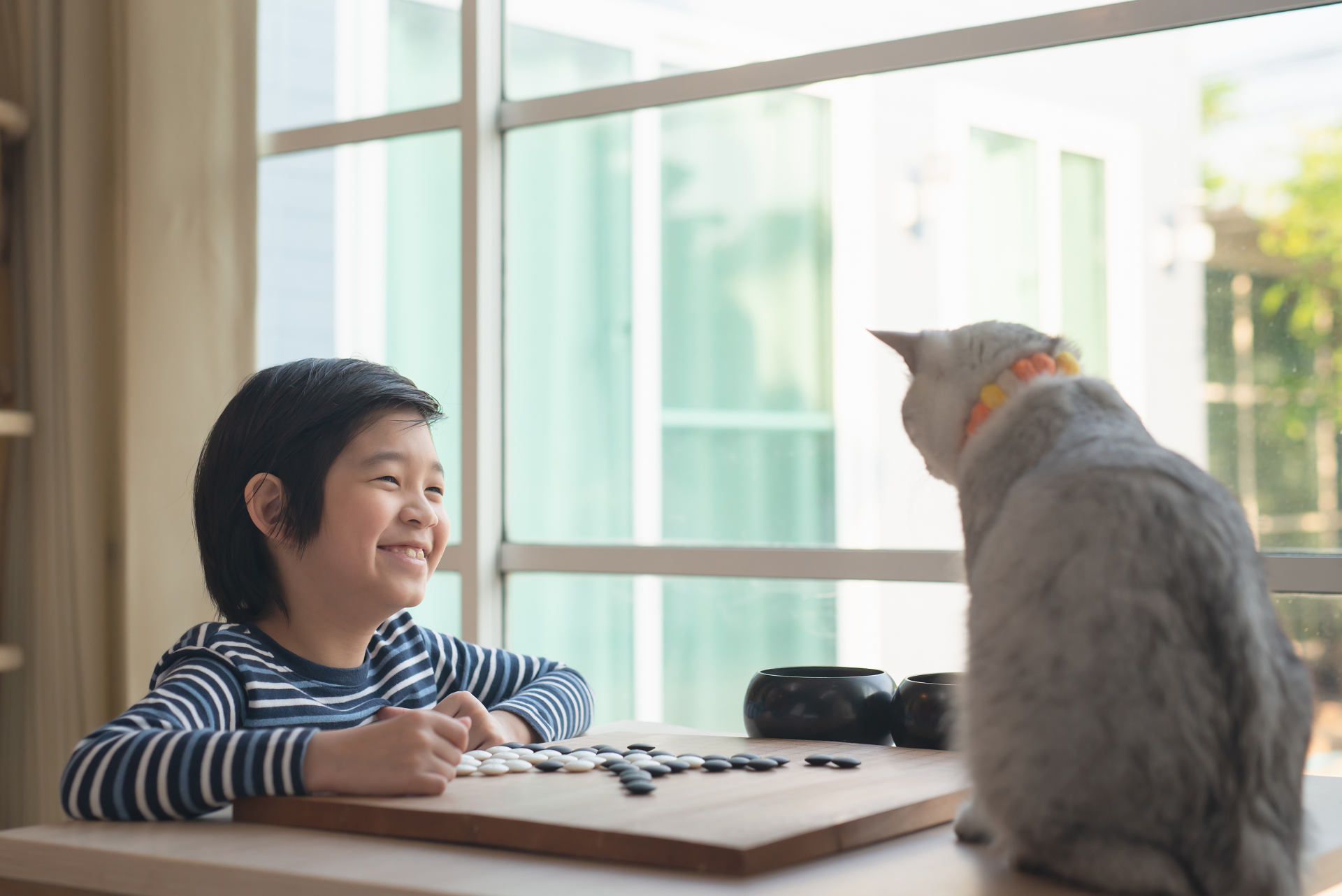 A happy toddler with his pet cat playing in a safe and pet-friendly house and lot in Laguna.